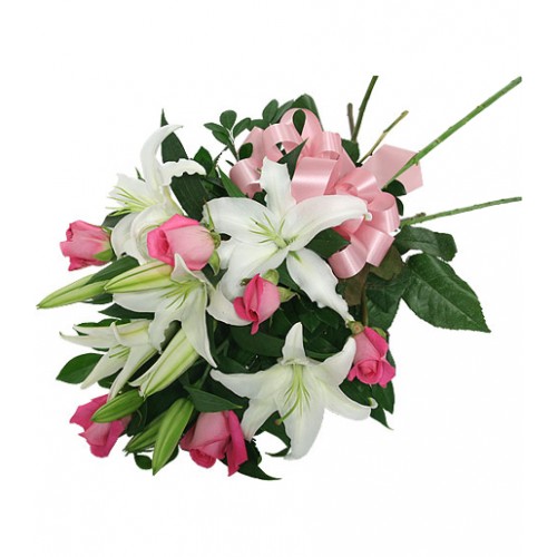 Lovely presentation of white fragrant lilies with long stemmed pink roses, wrapped with added greens and tied with a pink bow. Simple & affordable. Order directly with a florist online today!
