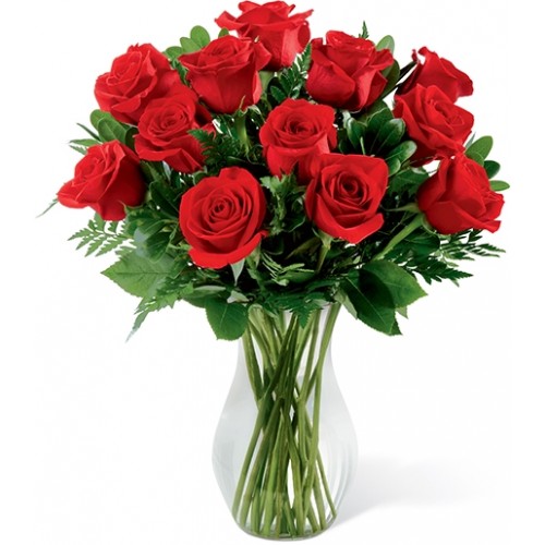 A classic expression of love and sweet affection! A dozen red roses arrive accented with lush greens, all beautifully arranged in a clear glass vase.