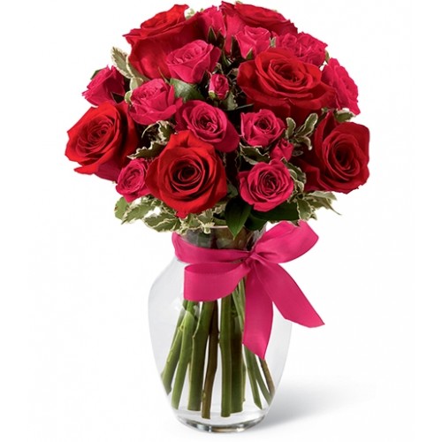 Bright red roses & hot pink spray roses artfully arranged among lush greens to create bouquet of passion & beauty. Set to usher in romance.