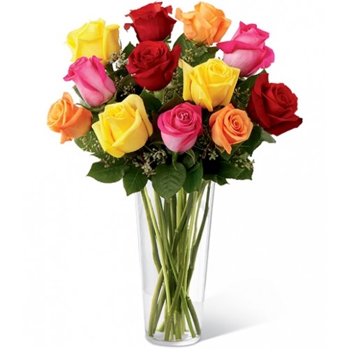 Spirited bouquet of roses in bold hues - hot pink, orange, red and bright yellow. Vivacious roses arranged with seeded eucalyptus in a clear glass vase.