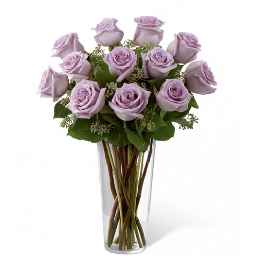 Bouquet of lavender roses sweetly touches her heart paired with seeded eucalyptus in a stylish glass vase, these lovely roses are a perfect gift.
