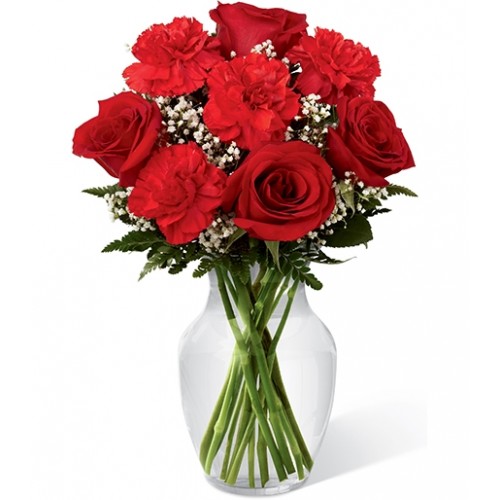 Rich red roses & carnations beautifully set amongst baby's breath & lush greens in classic clear glass vase. Send your sweet sentiment of love.