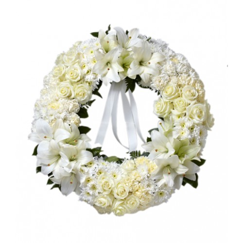 Exceptionally impressive wreath to deliver your condolences. Constructed of white roses, carnations & Asiatic lilies with lush greens & ribbon.